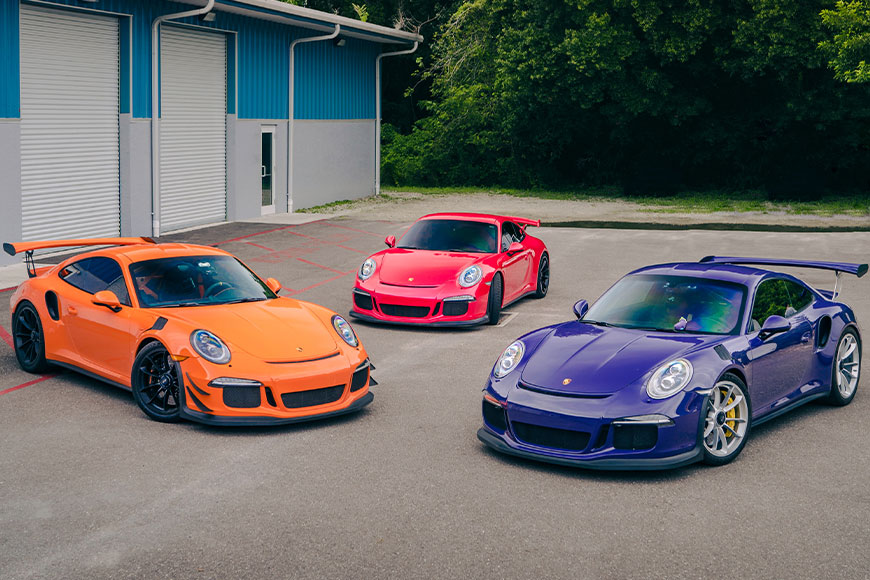 Three Porsches parked next to each other