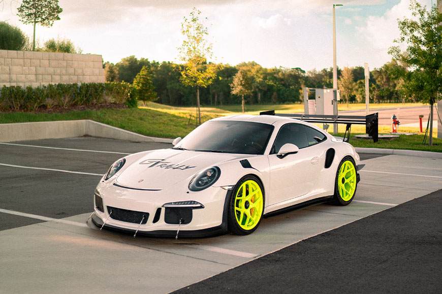 White Porsche with neon green wheels